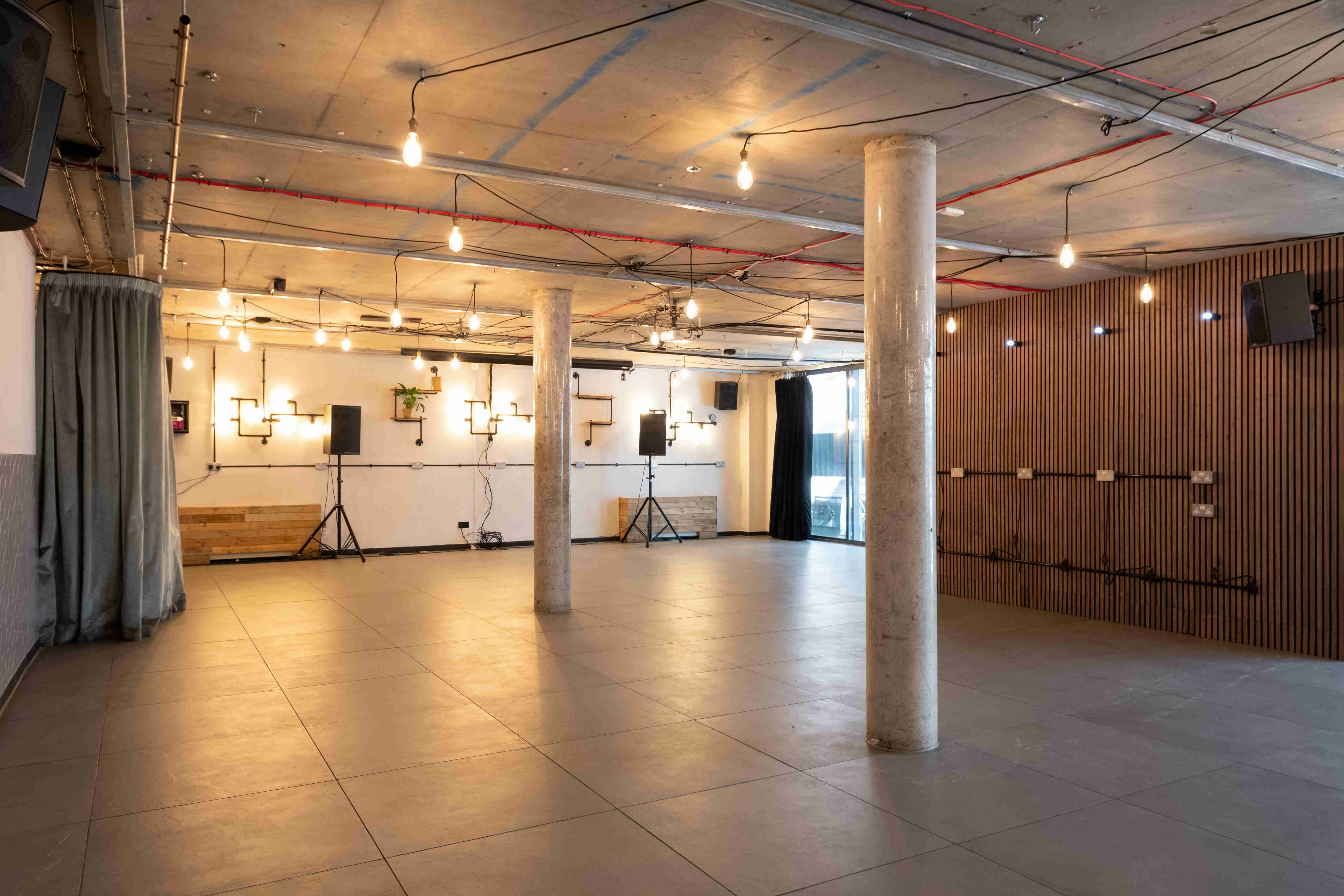 Versatile event space with polished flooring, ideal for meetings and workshops.