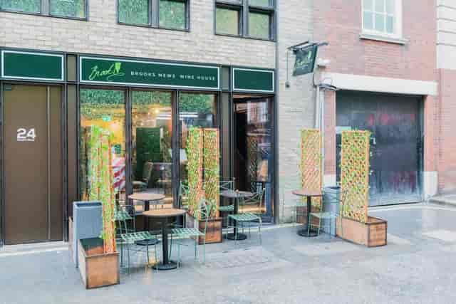 Charming outdoor seating at Brooks Mews Wine House for casual meetings and networking.