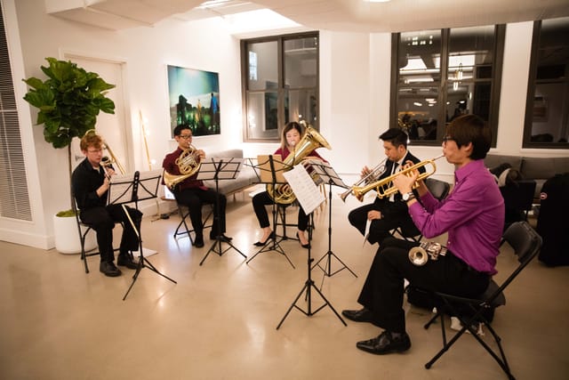 Brass ensemble performing in modern lounge for upscale events and receptions.