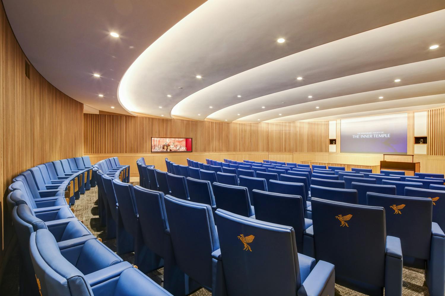 Modern lecture theatre with tiered seating, ideal for corporate meetings and seminars.