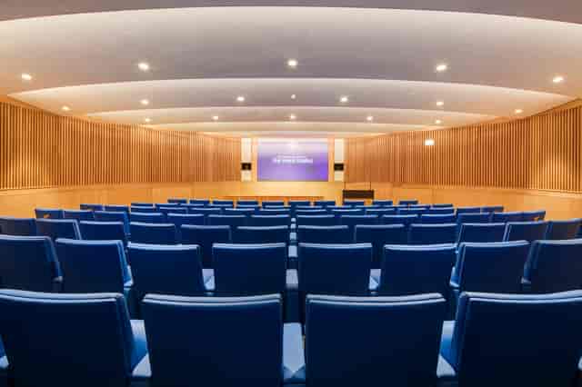 Modern lecture theatre with tiered seating for conferences and presentations.