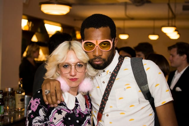 Vibrant networking event in Blender Workspace with stylishly dressed attendees.