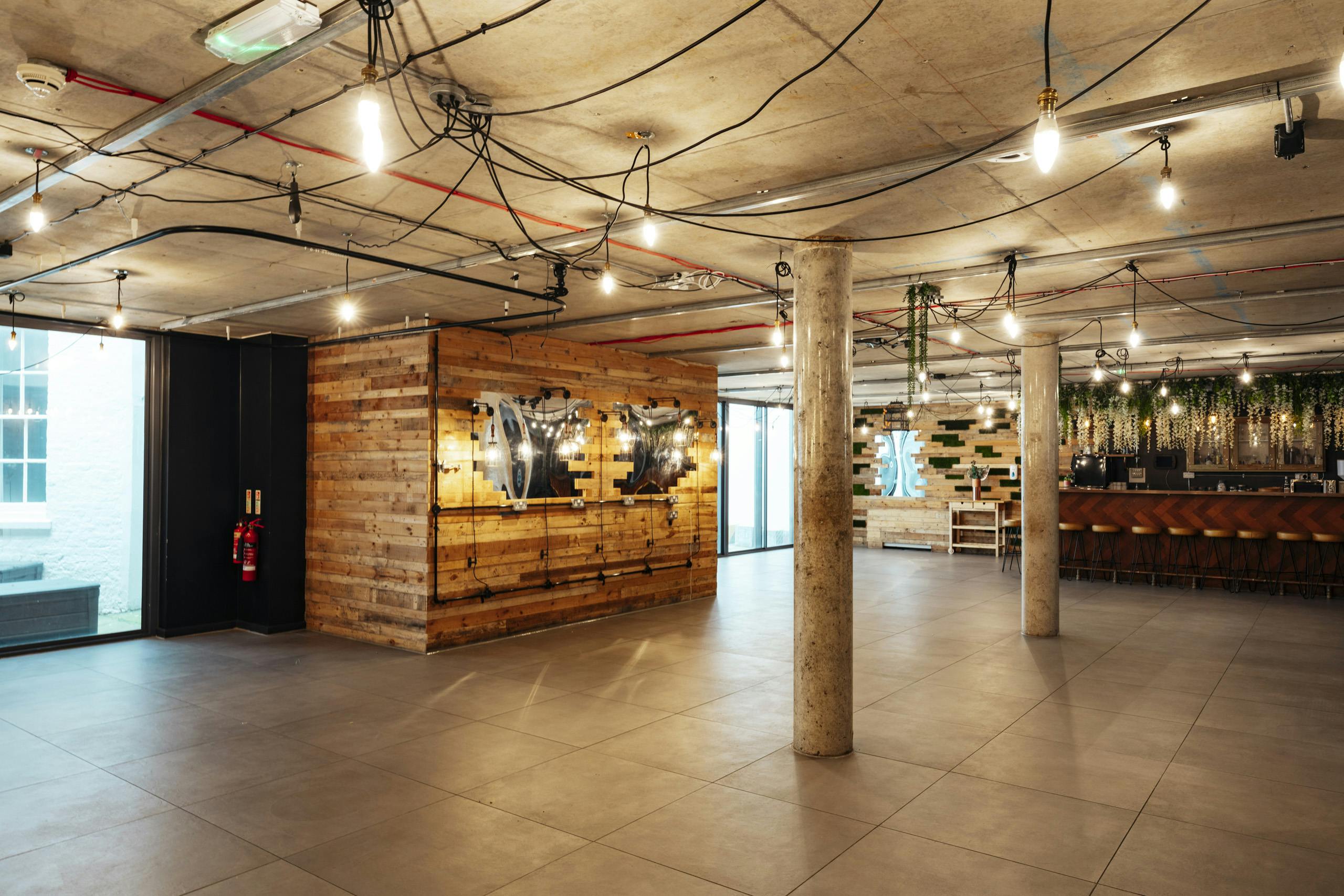 Versatile event space with industrial-chic design for corporate meetings and social gatherings.