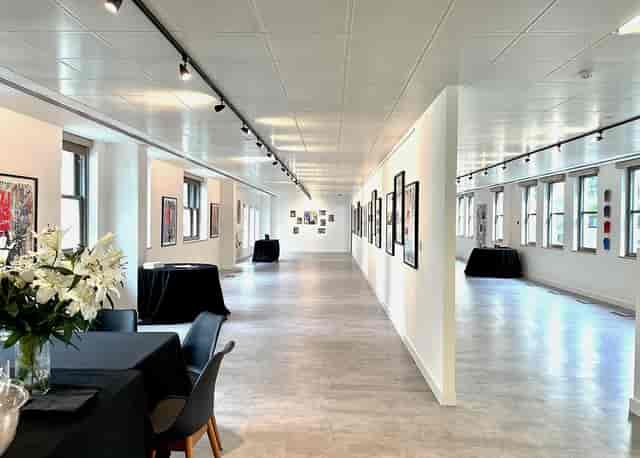 Red Wolf Mayfair gallery space set for networking event with professional track lighting.