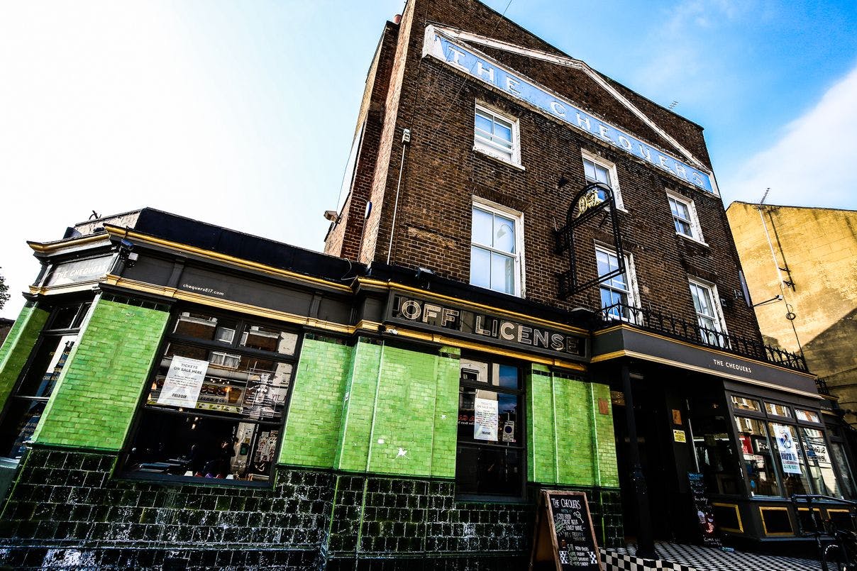 Vibrant green pub exterior at The Chequers, perfect for networking events and gatherings.