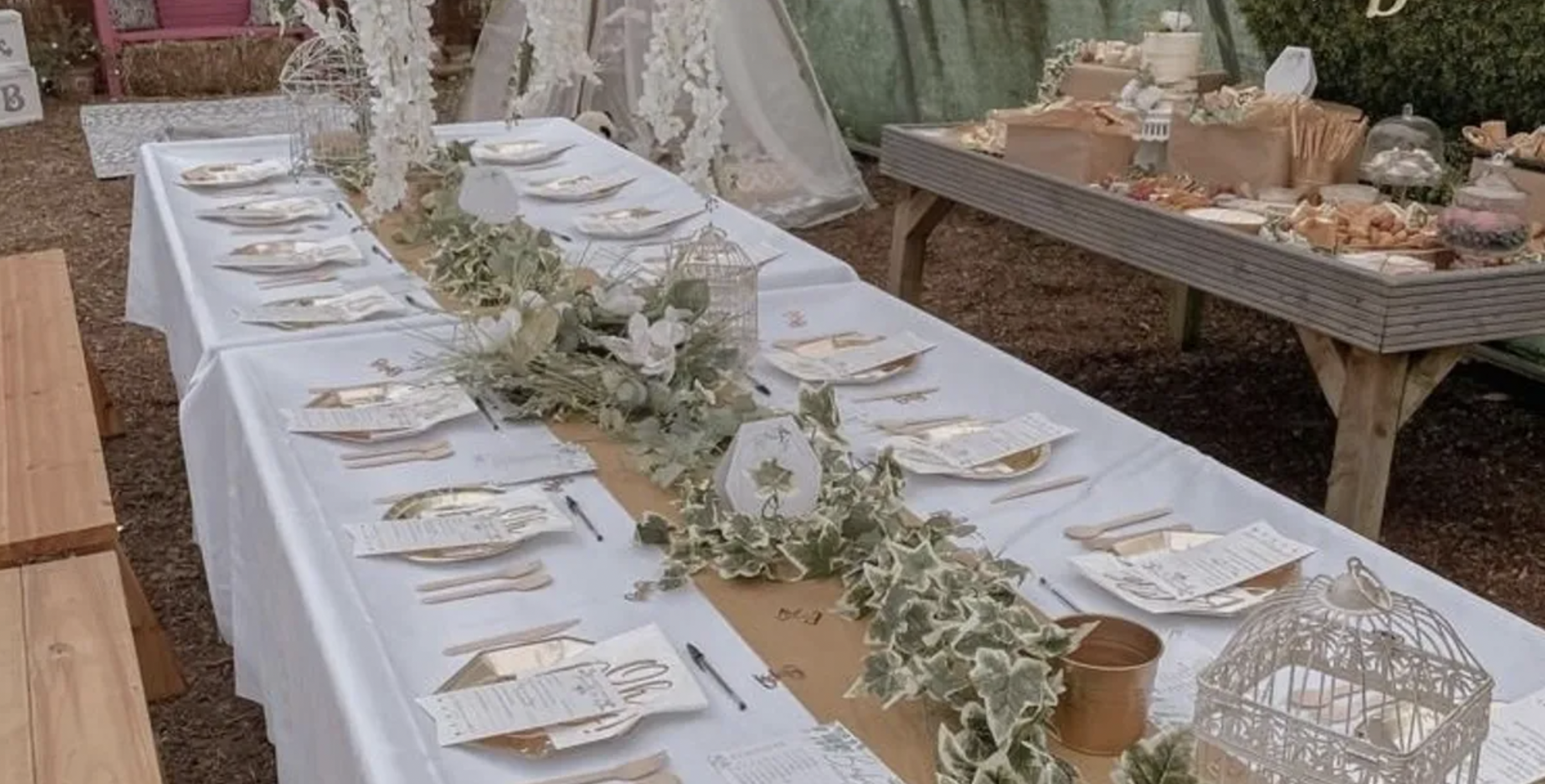 Elegant event table with white linens and floral decor at Secret Garden Event Space. - Banner