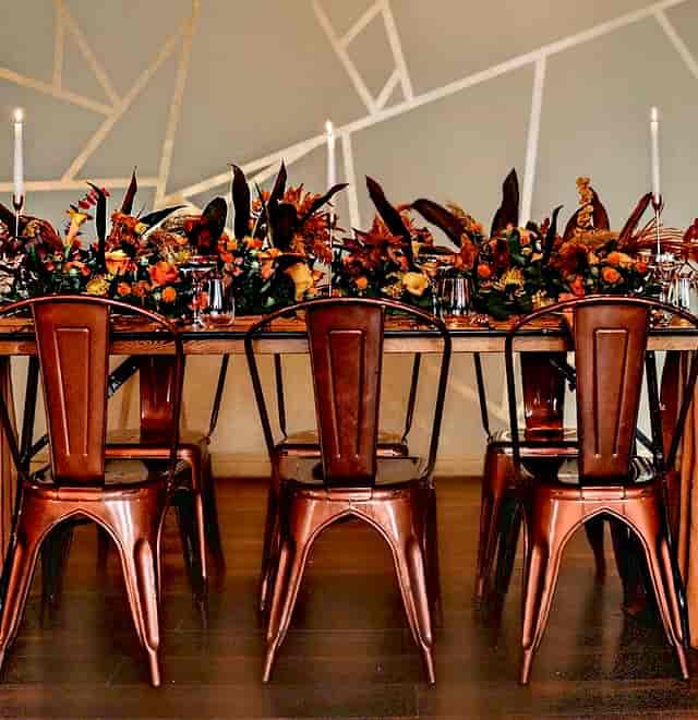 Industrial-chic copper seating with autumnal florals at The Venue on Middle St for event styling.