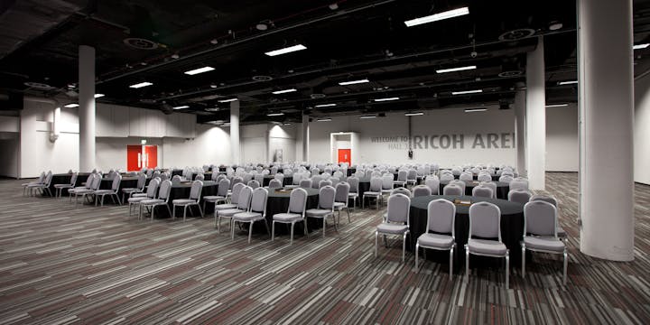 Spacious Coventry Arena event venue with round tables, ideal for conferences and banquets.