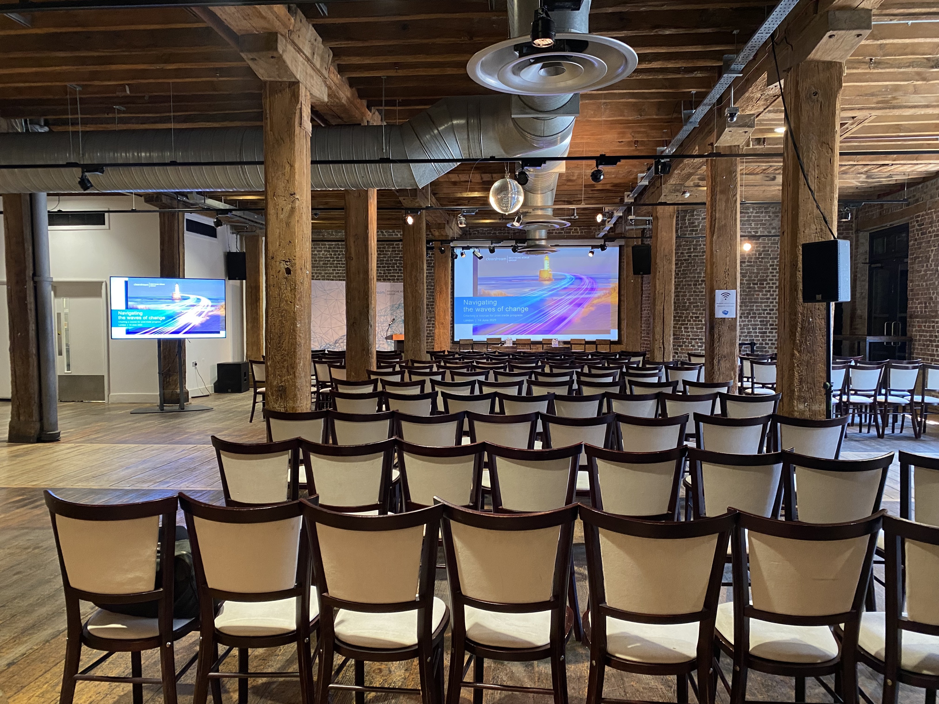 Riverside Room at London Museum Docklands, ideal for conferences with dual screens. - Banner