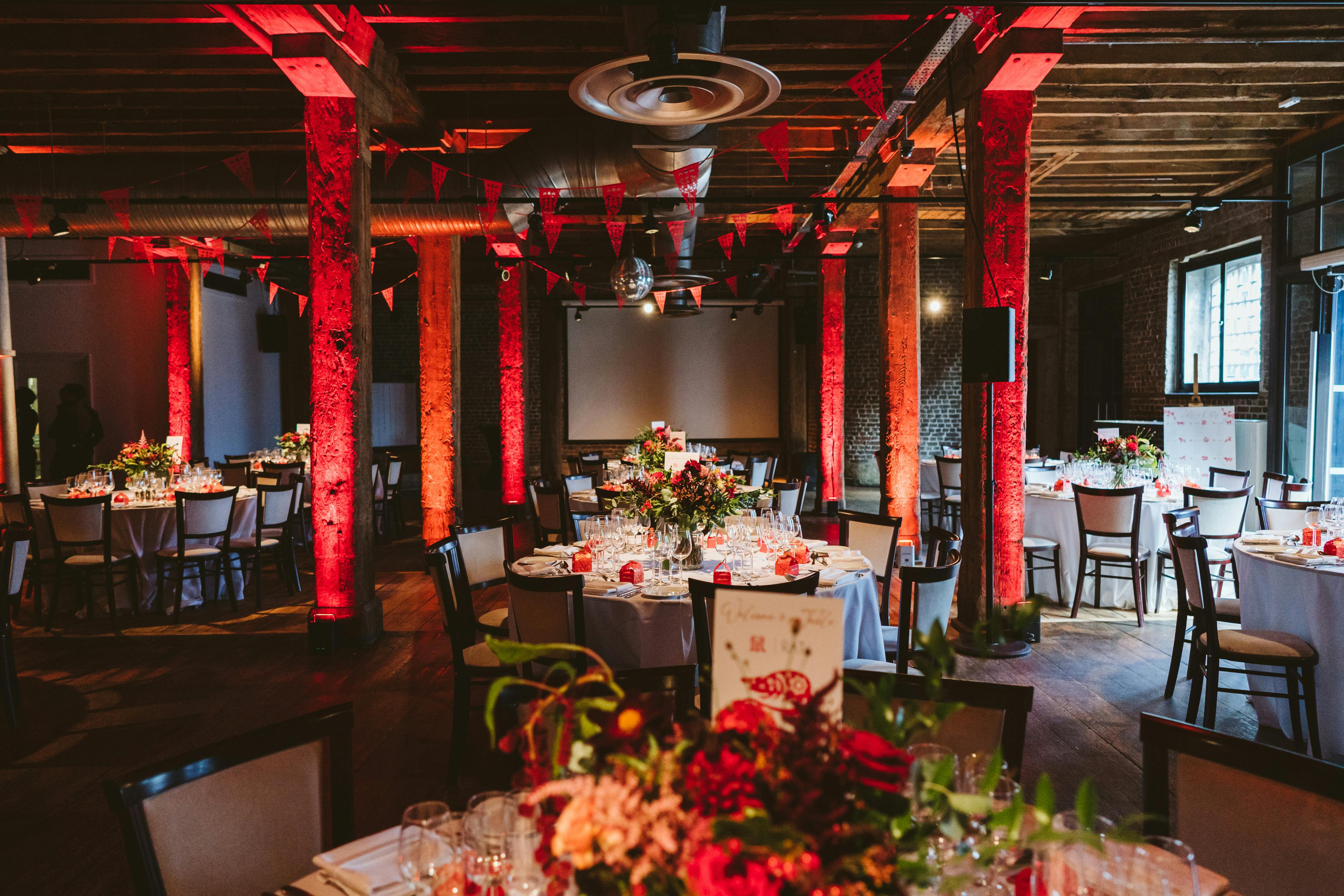 Riverside Room at London Museum Docklands, elegant event space with floral centerpieces.