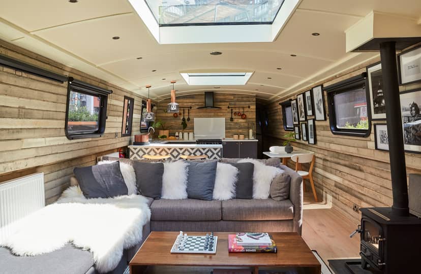 Boutique hotel boat interior with rustic wood, ideal for creative meetings in London.