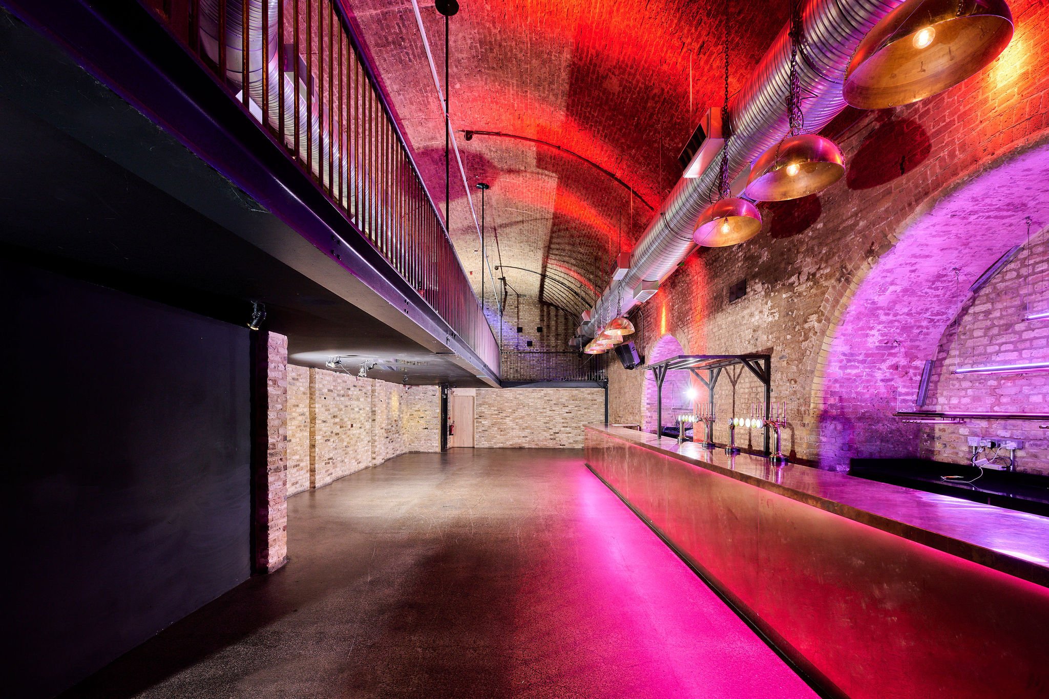 Stylish industrial event space with exposed brick, ideal for corporate and social gatherings. - Banner