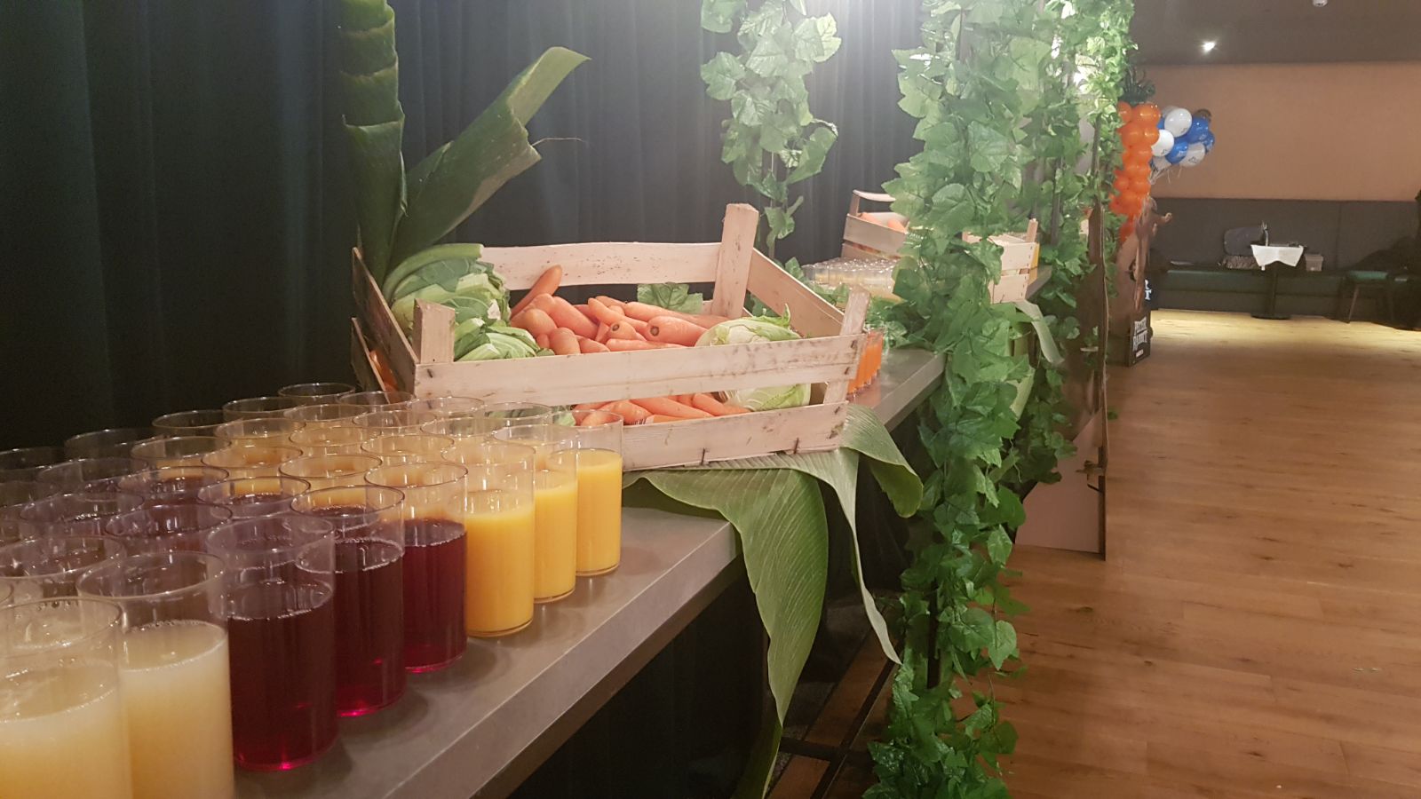 Vibrant refreshment station with colorful juices at VUE West End event.
