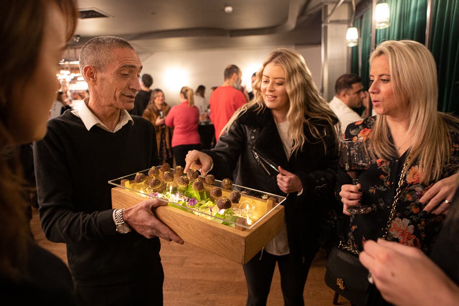Vibrant networking event at VUE West End with gourmet hors d'oeuvres and engaged attendees.