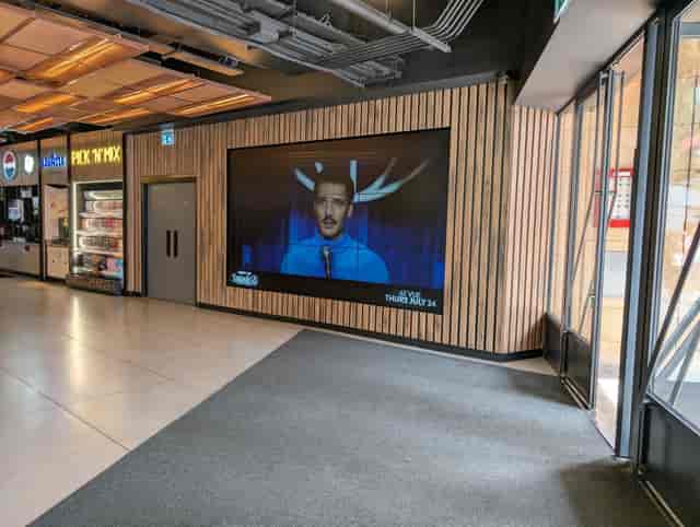 Modern digital signage wall in Vue West End cinema lobby for corporate events and brand activations.