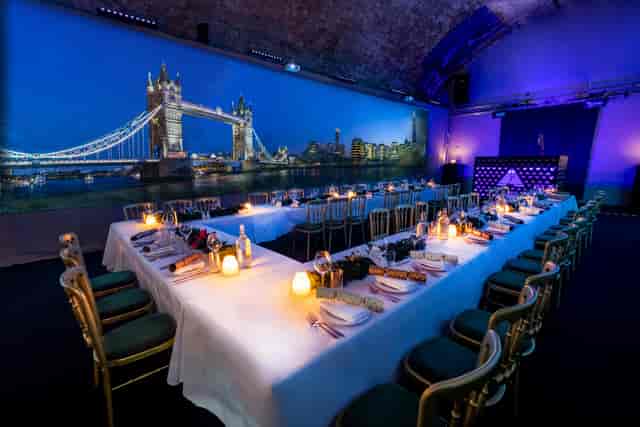 Elegant U-shaped dining setup for corporate events at Aures London with Tower Bridge backdrop.
