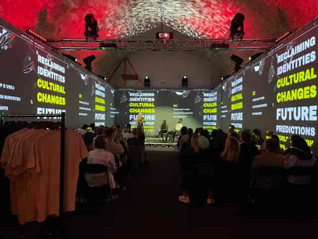 Dynamic panel discussion at Aures London, vibrant lighting, corporate event.