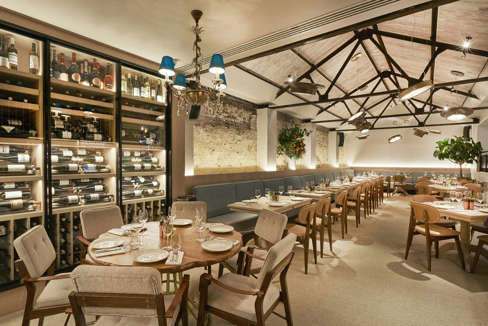 Stylish Meraki London restaurant with elegant wooden furniture for intimate events.