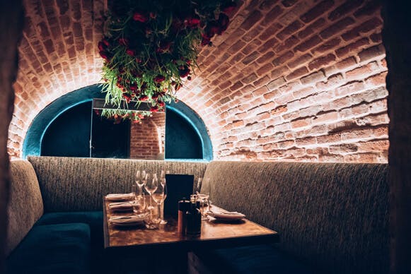 Intimate arched brick dining space at The Caves, Meraki London for private events.