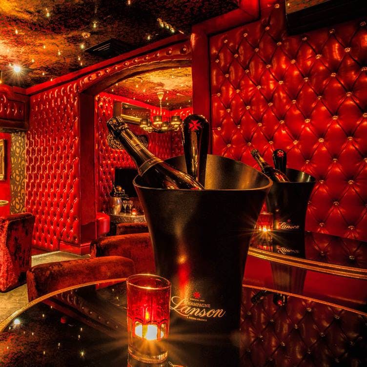 Luxurious Red Room at 1989 Clubhouse, perfect for exclusive events and celebrations.