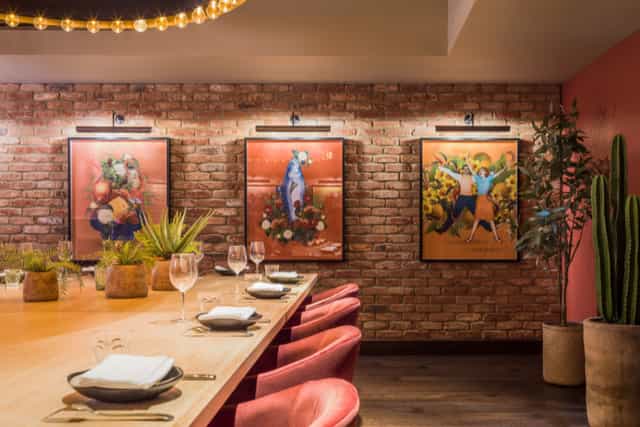 BIBO Private Dining at Virgin Hotels, stylish wooden table for intimate gatherings.
