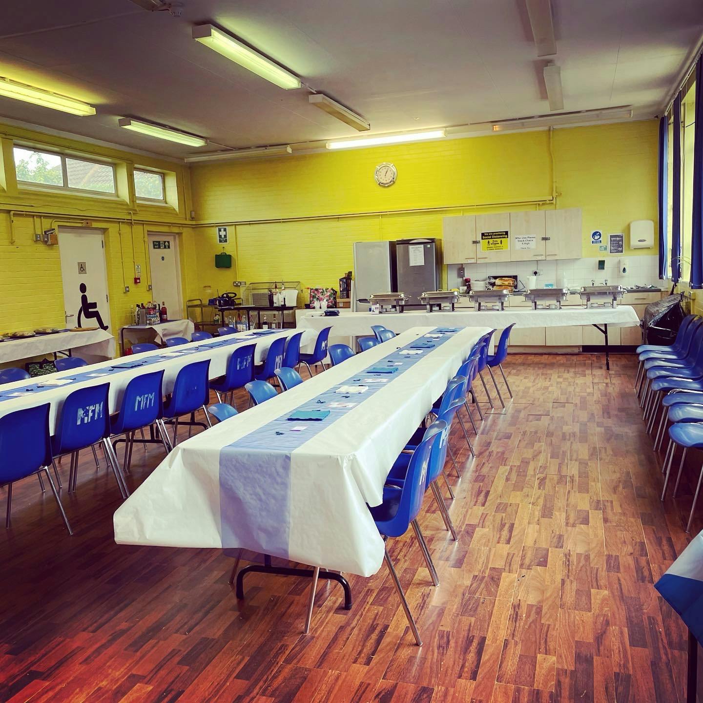 William Hall event space with blue and white tables, perfect for banquets or meetings.