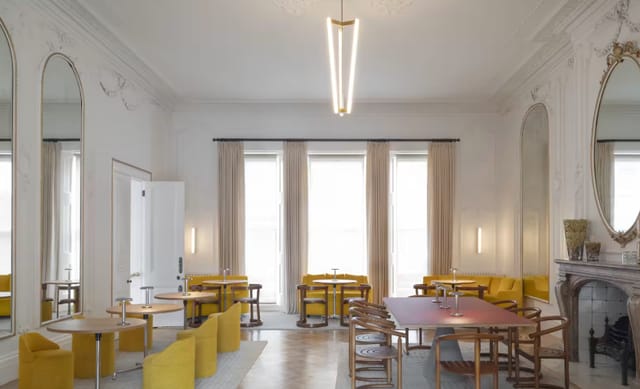 Cromwell Place Café Bar: stylish meeting space with yellow seating for workshops and gatherings.