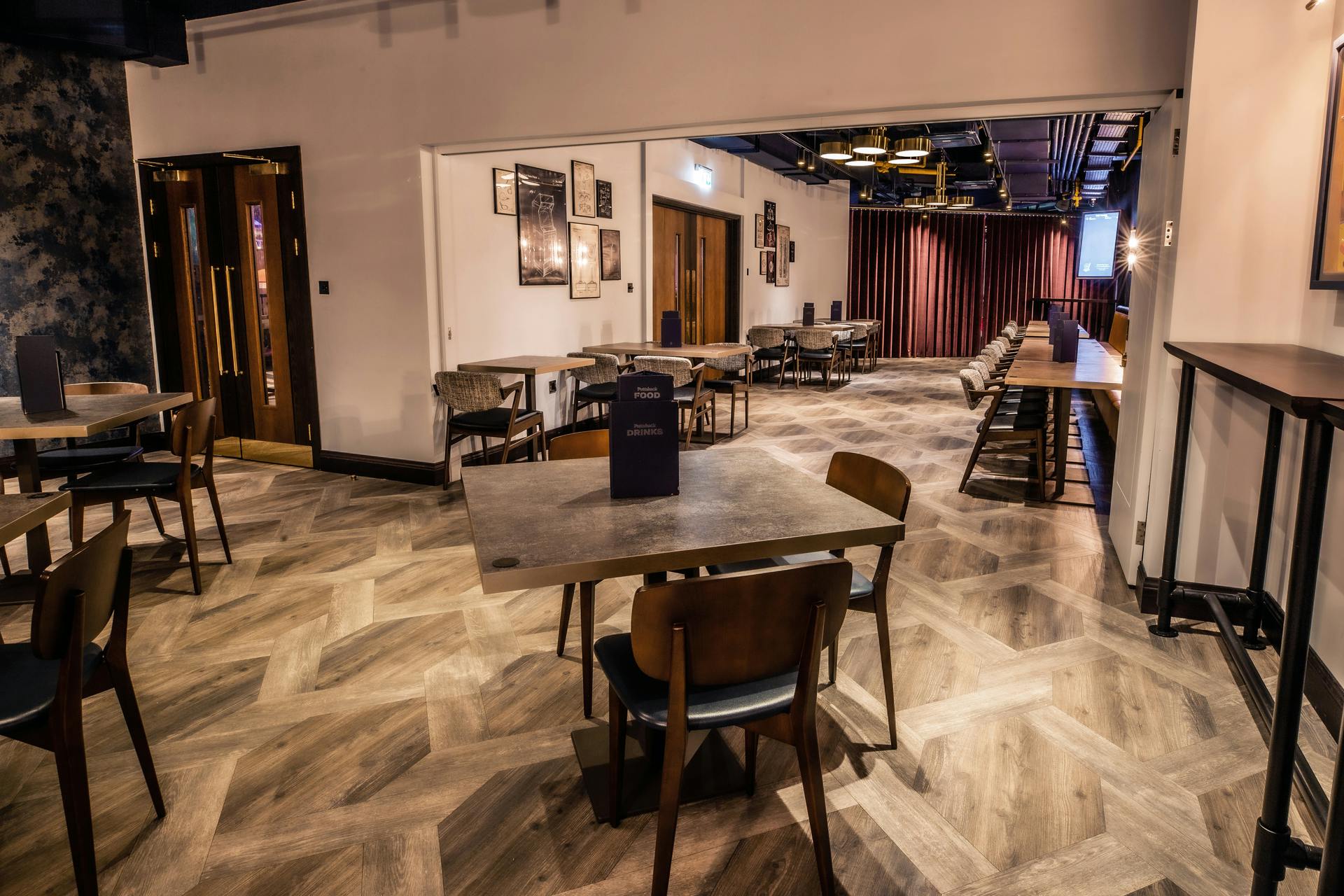 Half Venue Hire at Puttshack Watford, modern space with wooden flooring for events.