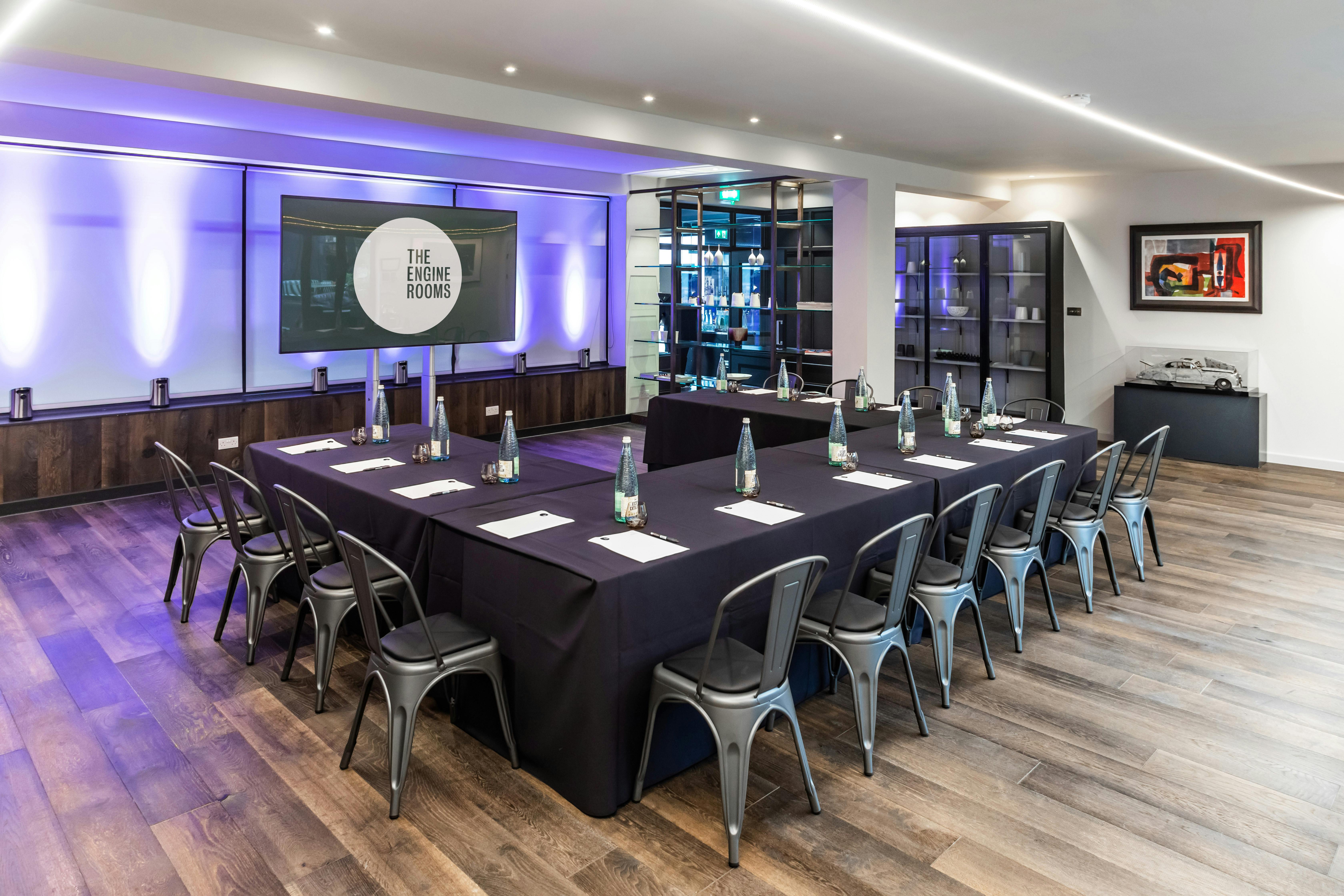 Modern meeting room with sleek table, ideal for professional gatherings and events.