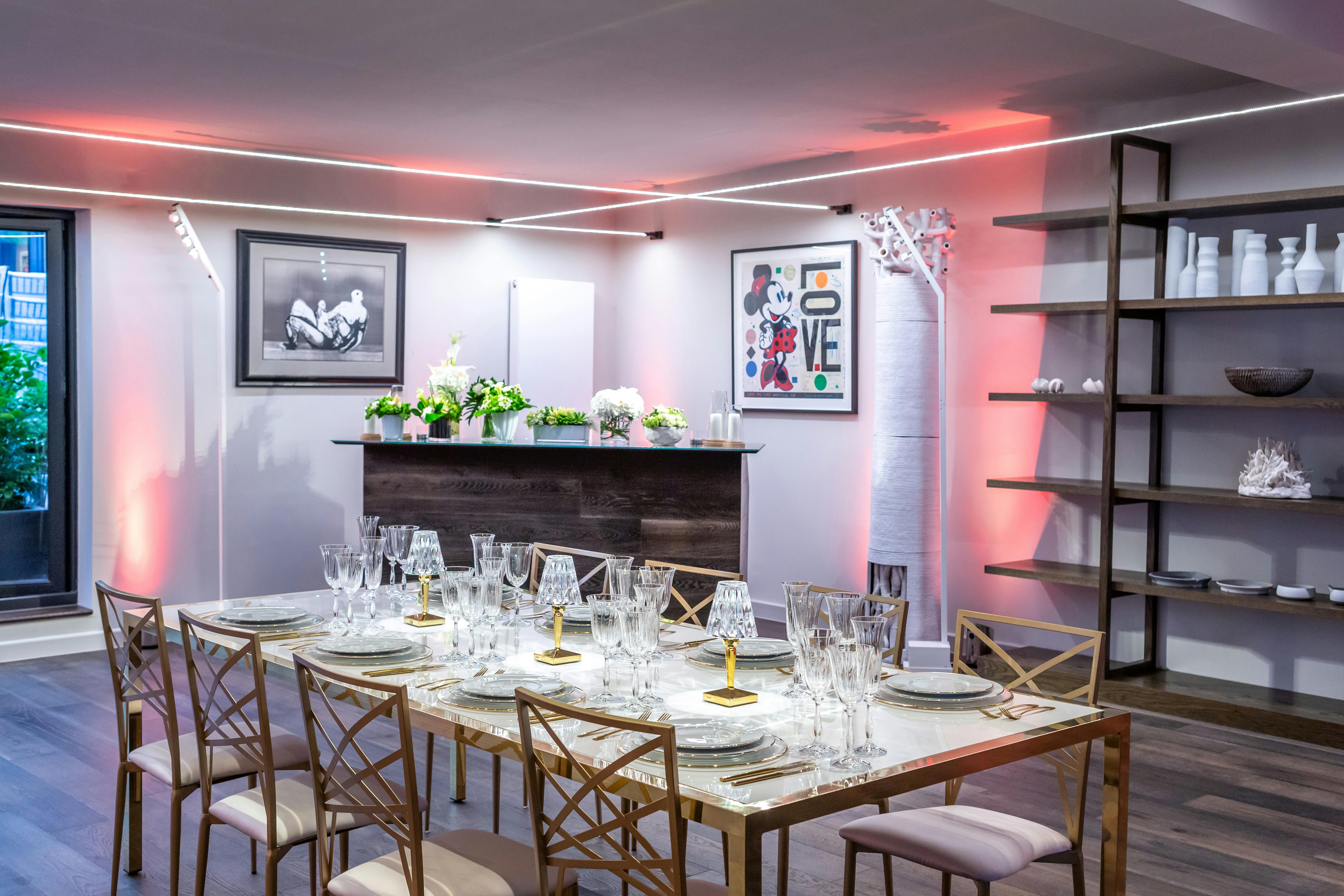 Elegant dinner setup in The V8 Room, featuring crystal glassware and modern decor.