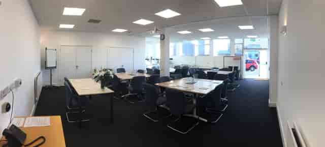 Modern conference suite with natural light, perfect for workshops and team meetings.