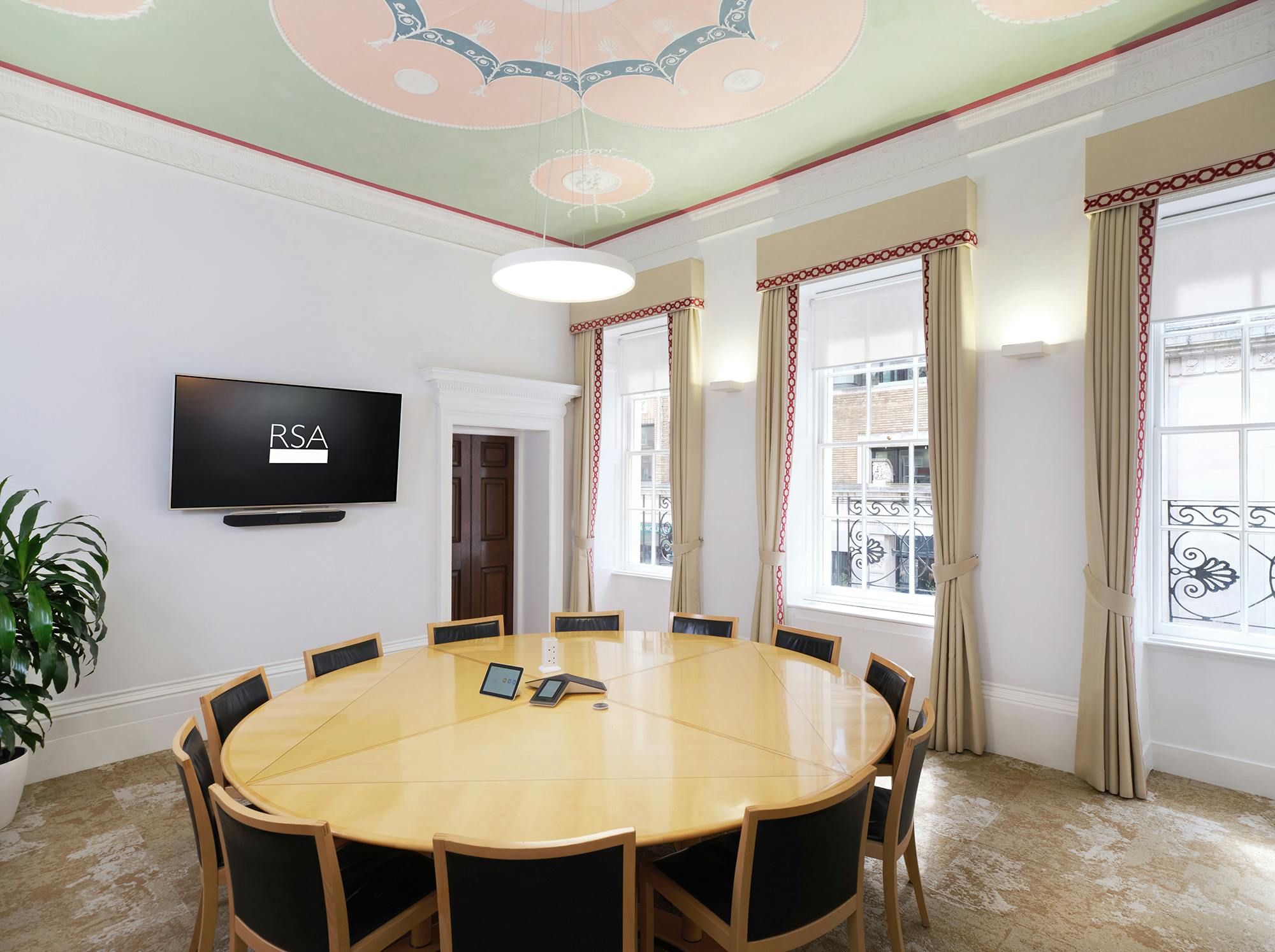 The Shipley Room at RSA House: elegant meeting space with round table for presentations.