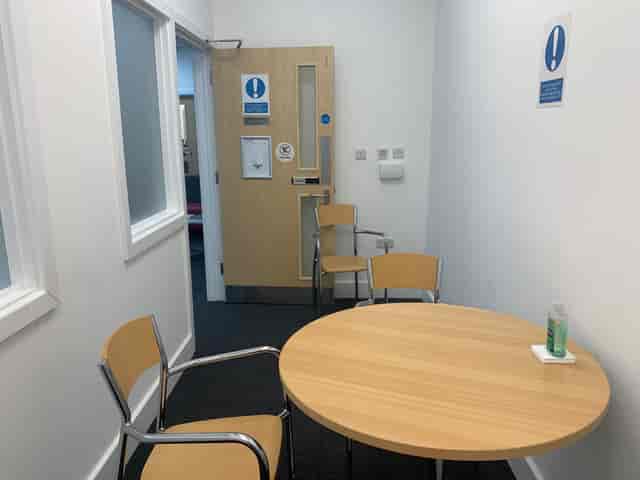 Small meeting room with round table for intimate discussions and professional events.