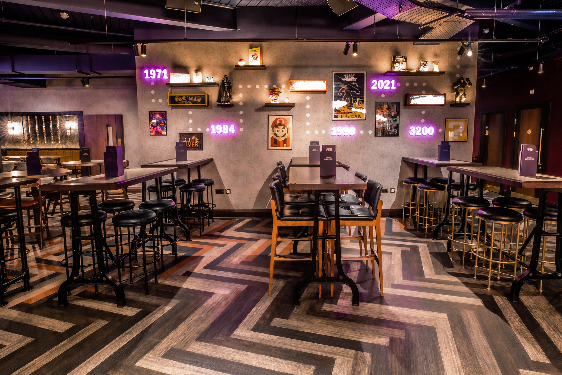 Sapphire semi-private event space at Puttshack Watford with stylish seating and vintage decor.