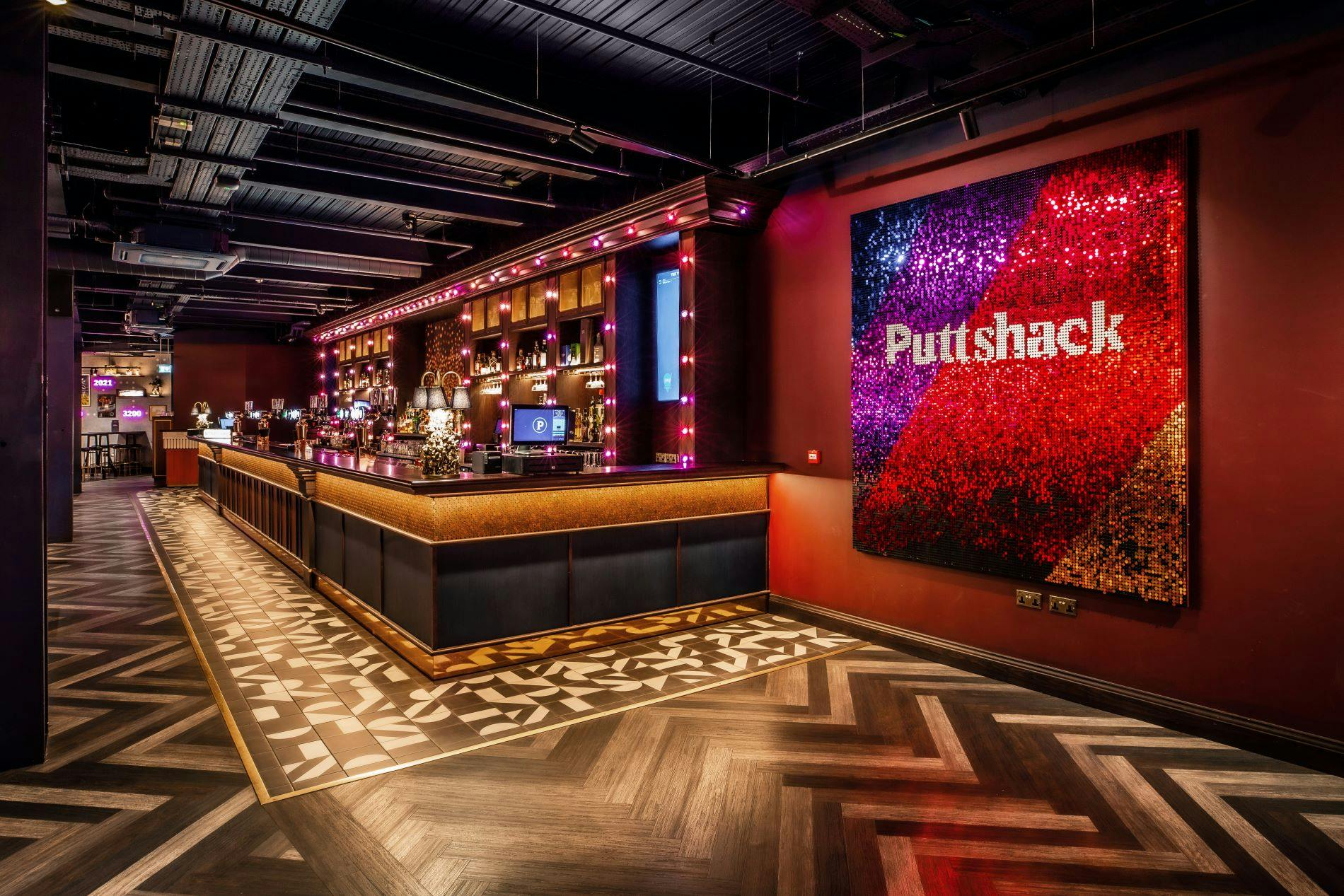 Christmas at Puttshack Watford, vibrant venue with stylish bar for events and gatherings.