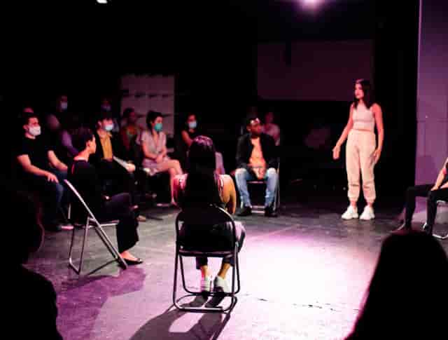 "McQueens Theatre performance with audience in masks for interactive workshops and events."