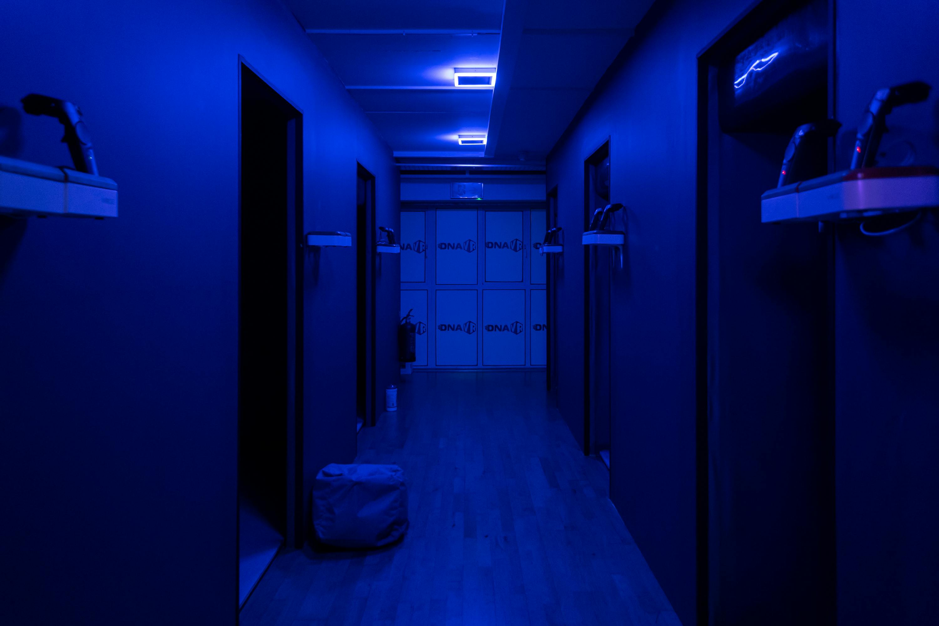 DNA VR Camden corridor with blue lighting, ideal for immersive events and gatherings.