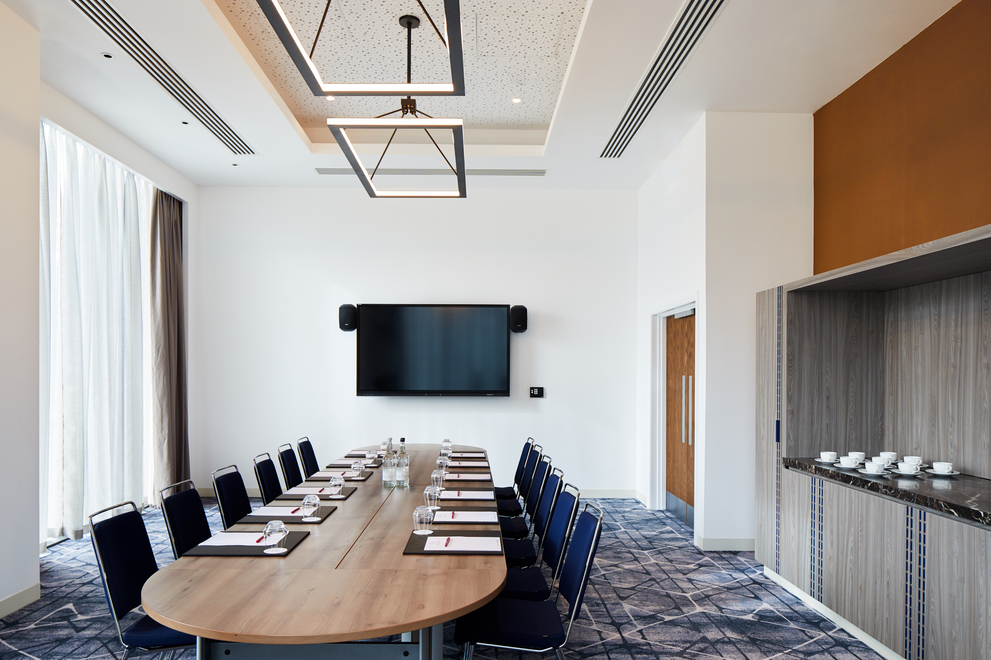Modern Executive Boardroom at Hyatt Regency Manchester, ideal for meetings and presentations. - Banner