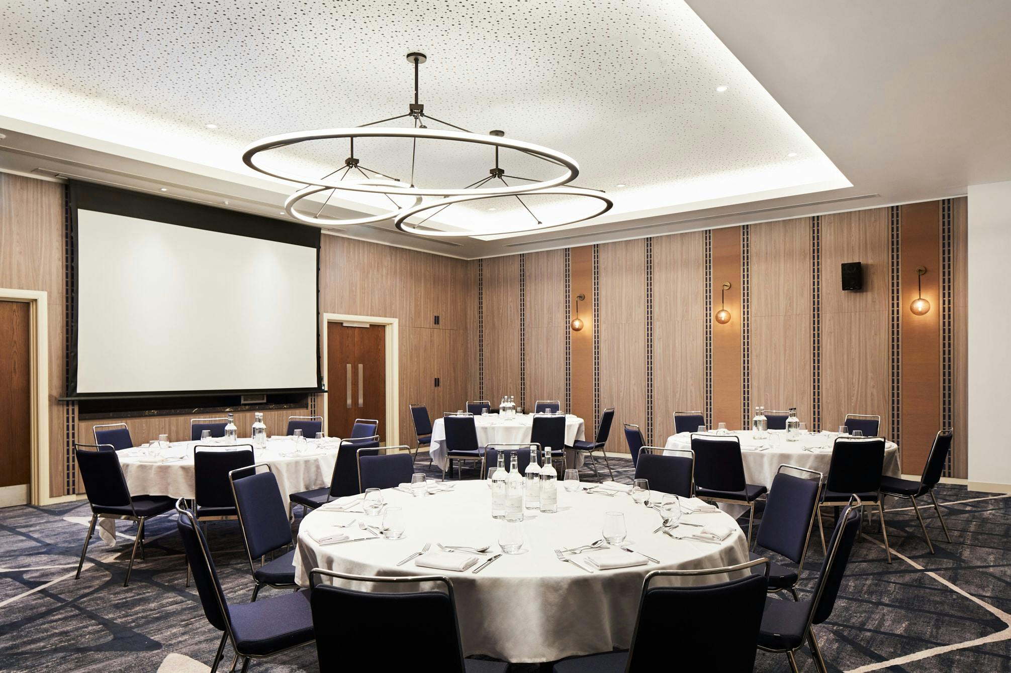 Hyatt Regency Manchester Waterhouse Room with round tables for meetings and events.