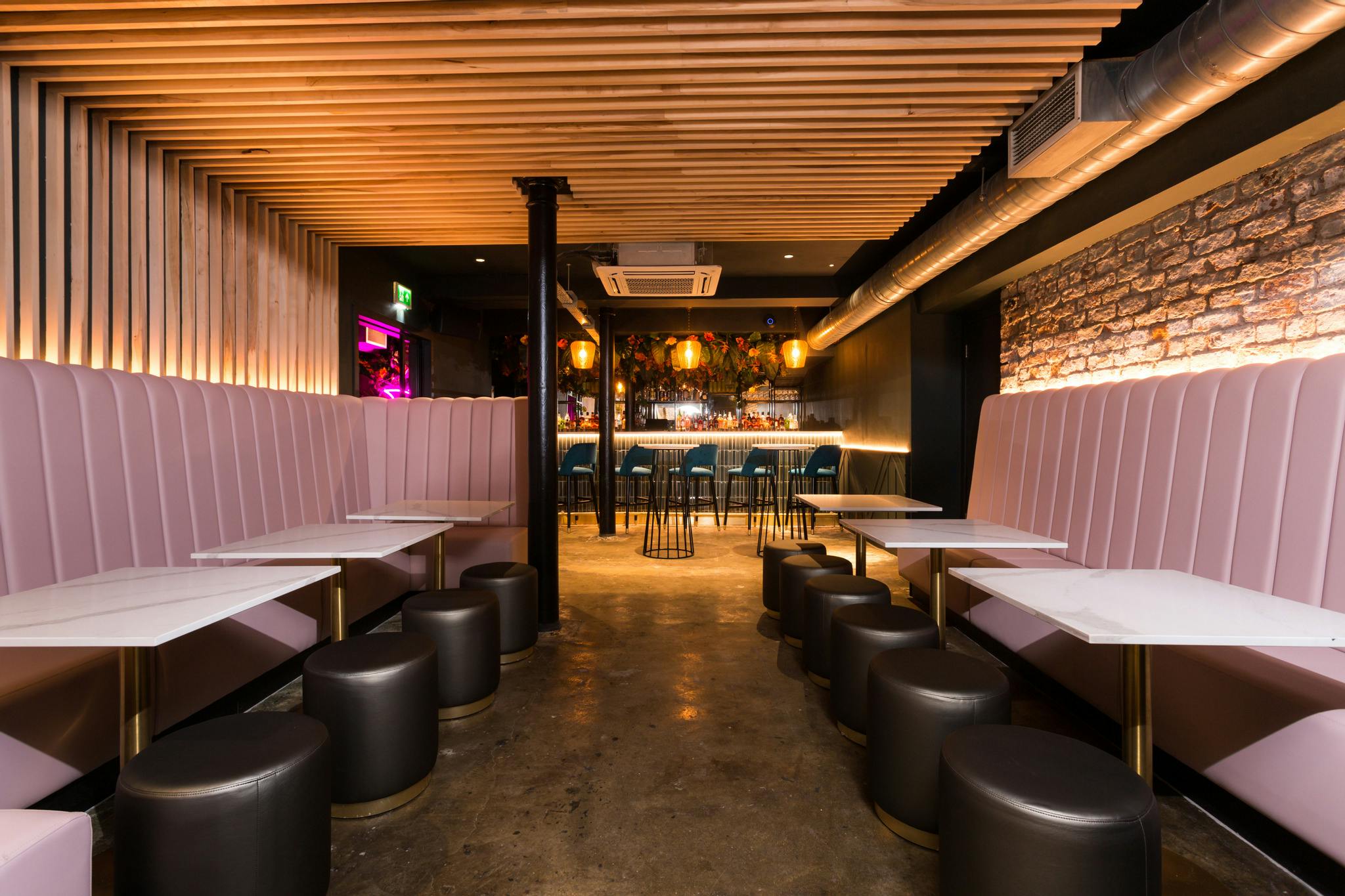 Stylish basement bar in Lono Cove with plush seating, perfect for networking events.