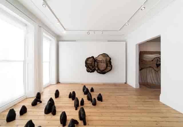 Minimalist art gallery in Cromwell Place with black sculptures, ideal for exhibitions and events.