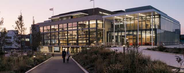 Modern Welcome Building venue with glass facades, perfect for events and meetings.