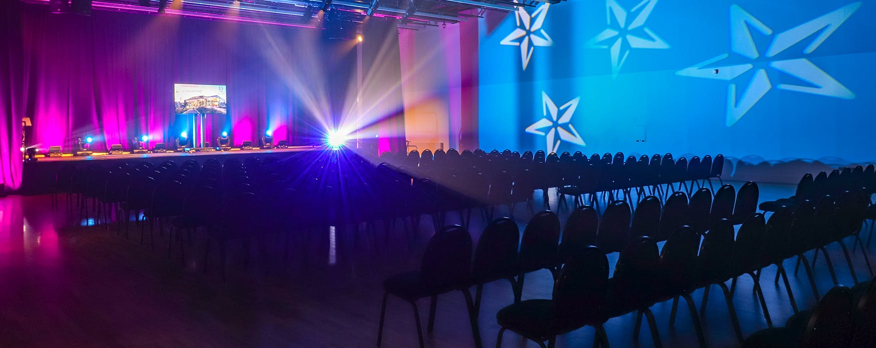 Welcome Building event space with stage lighting for engaging presentations and performances.