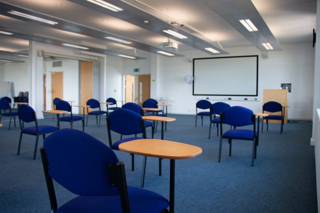 Spacious meeting room with blue chairs for safe workshops at Future Skills Centre.