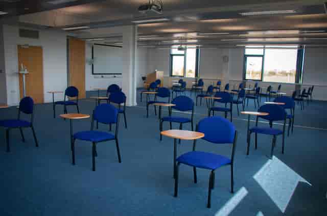 Spacious meeting room with chairs and tables for workshops at Future Skills Centre.