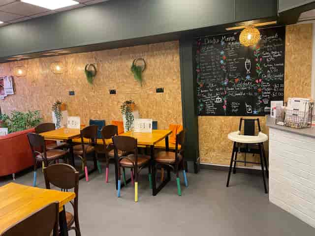 Cozy Serenity Cafe meeting space with vibrant decor, perfect for casual events and gatherings.