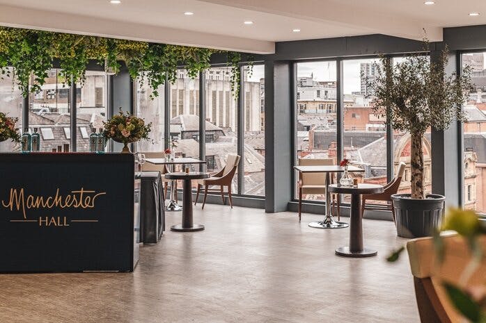 Modern event space at John Rylands Rooftop, Manchester Hall with large windows and greenery.