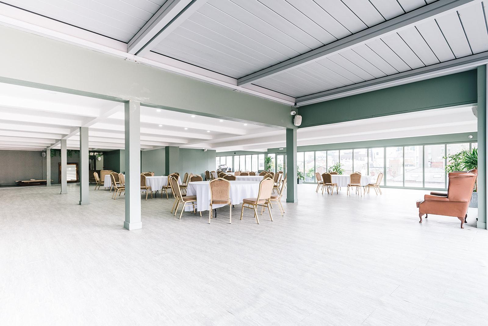John Rylands Rooftop in Manchester Hall, spacious event venue with large windows for gatherings. - Banner