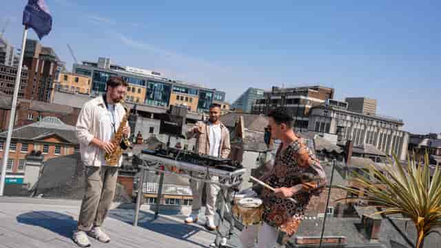 "John Rylands Rooftop event with live musicians in Manchester, ideal for corporate gatherings."