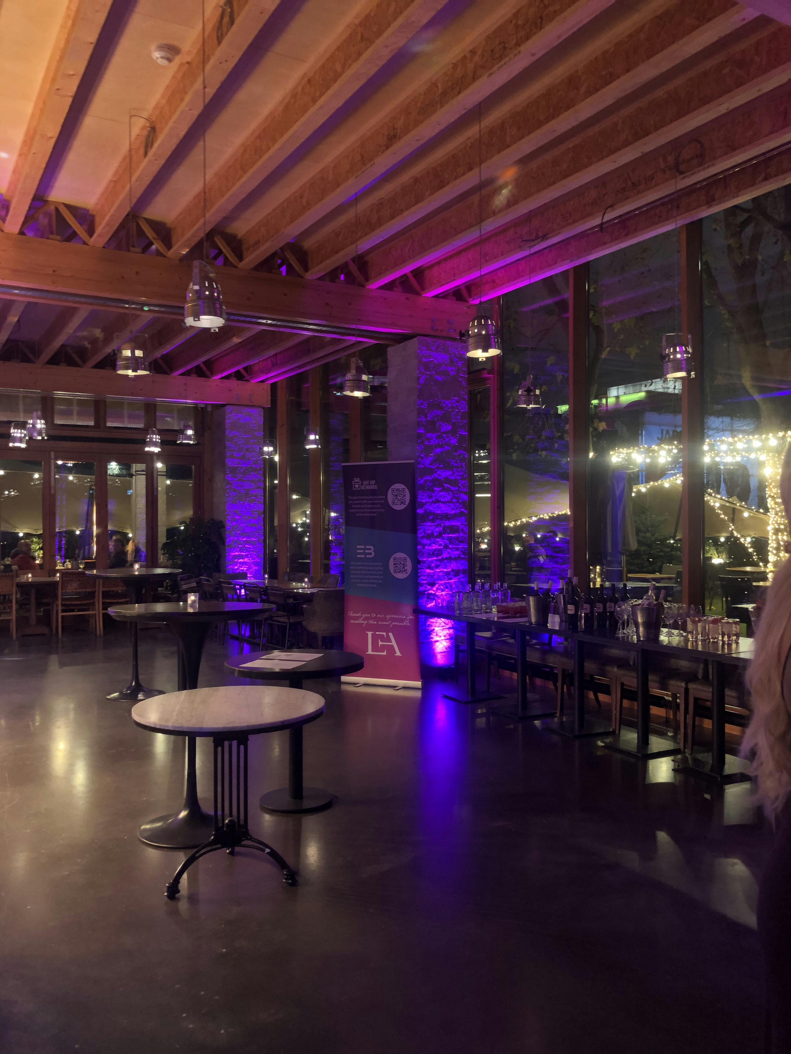 Stylish event space with ambient lighting, ideal for corporate gatherings and networking.